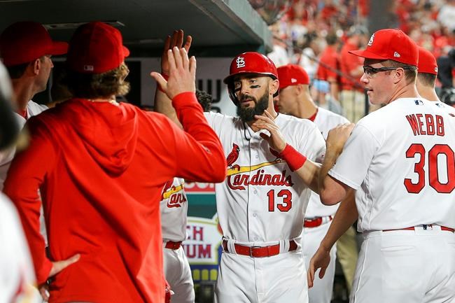 St. Louis Cardinals' Matt Carpenter (13) is congratulated by teammates after hitting a solo home run during the ninth inning of a baseball game against the Atlanta Braves, Friday, May 24, 2019, in St. Louis. (AP Photo/Scott Kane)