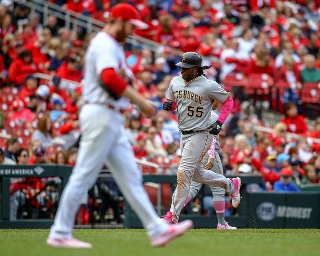 Pittsburgh Pirates' Josh Bell, right, runs the bases after hitting a three-run home run off of St. Louis Cardinals relief pitcher John Brebbia (60) during the seventh inning of a baseball game Sunday, May 12, 2019, in St. Louis. (AP Photo/Scott Kane)