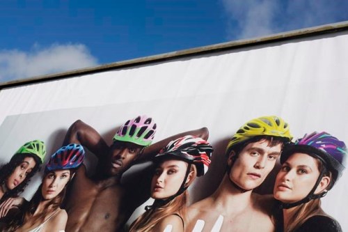 A poster of a bike helmet campaign is displayed in front of Germany's transport ministry in Berlin, Monday, March 25, 2019. The cycling safety campaign has drawn accusations of sexism even inside the governing coalition for featuring scantily clad women. (AP Photo/Markus Schreiber)