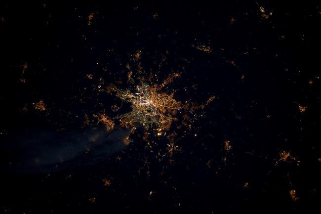 This undated photo provide by the European Space Agency and captured by ESA astronaut Andre Kuipers, shows the German capital Berlin from the International Space Station, ISS. Seen from above, street lights in the former East Berlin appear slightly more orange; those in the western part of the city are a harsher yellow. (ESA via AP)