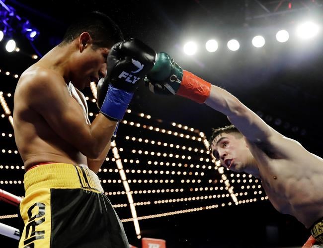 Ireland's Michael Conlan, right, punches Mexico's Ruben Garcia Hernandez during the fourth round of a featherweight boxing match Sunday, March 17, 2019, in New York. Conlan won the fight. (AP Photo/Frank Franklin II)