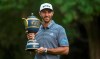 U.S. golfer Dustin Johnson poses with his Mexico Championship trophy at the Chapultepec Golf Club in Mexico City, Sunday, Feb. 24, 2019. (AP Photo/Christian Palma)