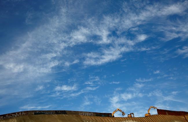 Workers replace sections of the border wall, left, with new sections, right, Tuesday, Jan. 8, 2019, in Tijuana, Mexico. Ready to make his case on prime-time TV, President Donald Trump is stressing humanitarian as well as security concerns at the U.S.-Mexico border as he tries to convince America he must get funding for his long-promised border wall before ending a partial government shutdown that has hundreds of thousands of federal workers facing missed paychecks. (AP Photo/Gregory Bull)
