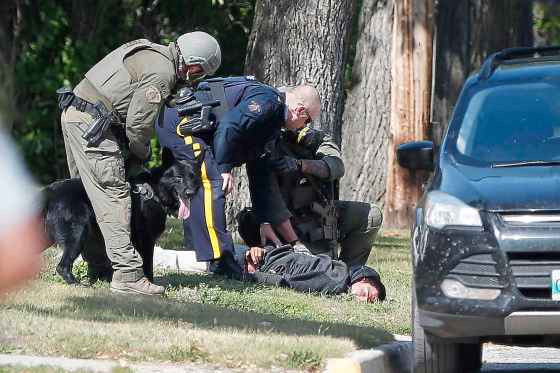 CPThe RCMP emergency response unit arrests an alleged suspect in Neepawa, Man., on Thursday, August 30, 2018, following the shooting of a RCMP officer in Onanole, Man. THE CANADIAN PRESS/John Woods