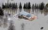 MIKE DEAL / WINNIPEG FREE PRESS Archives
A house with a breached sandbag dike is flooded off Breezy Point Road north of Selkirk during the 2011 flood. A task force says the 2011 flood was the largest and most severe in the province's recorded history.