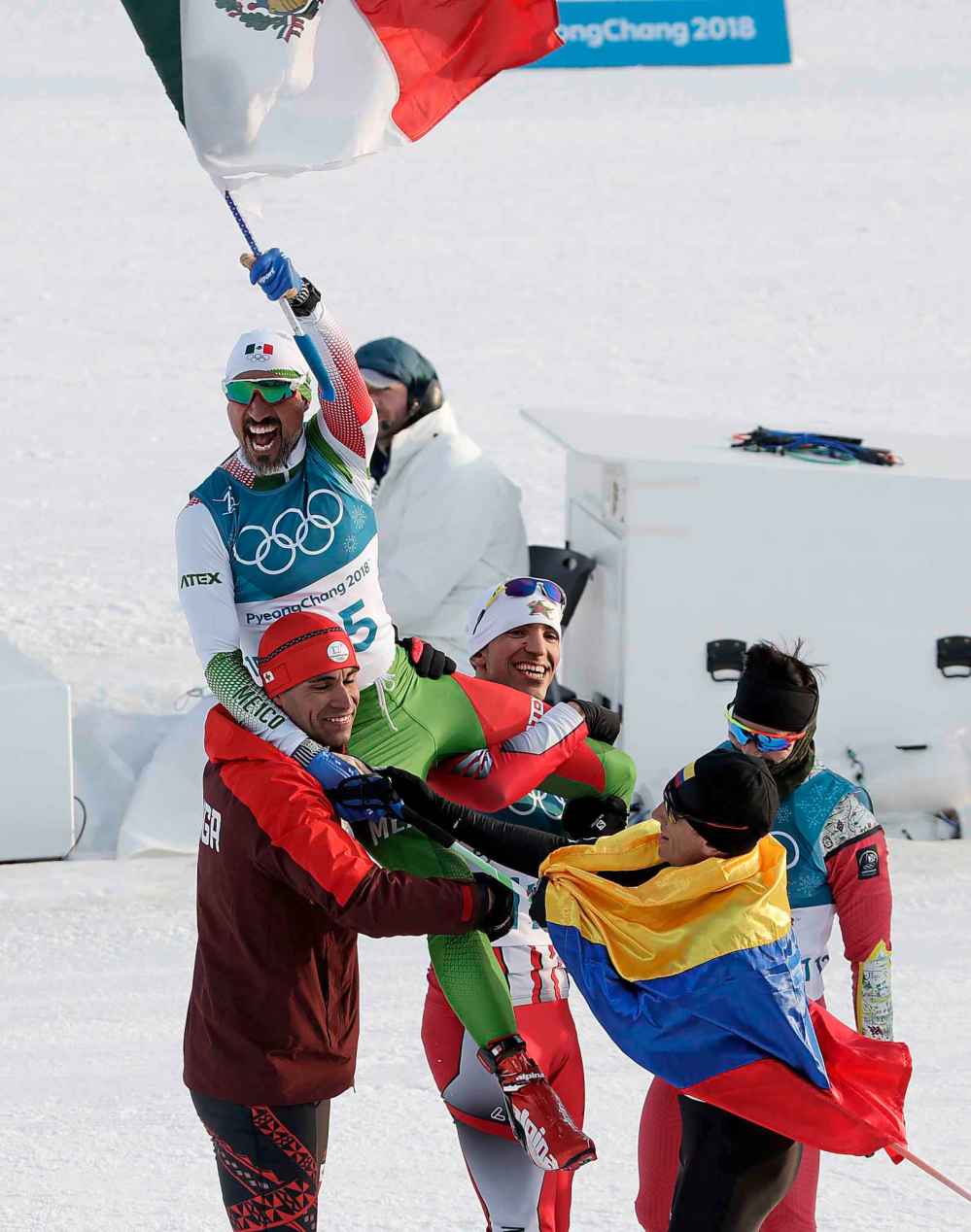 (AP Photo/Dmitri Lovetsky)
German Madrazo, of Mexico, holds up his countries flag after finishing last in the men's 15km freestyle cross-country skiing competition in Pyeongchang, Friday.