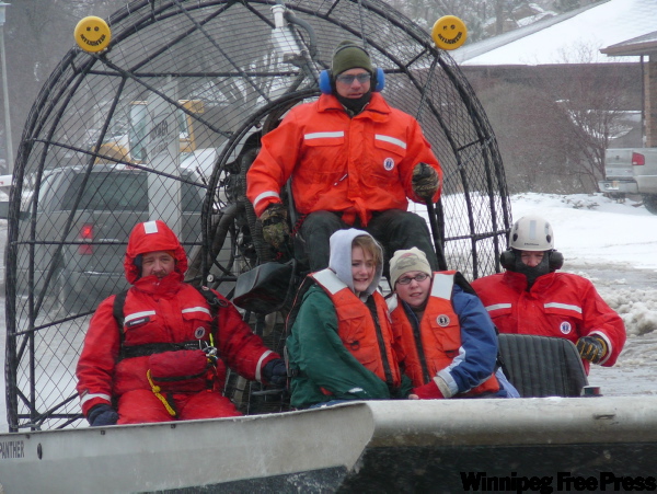 NATE JENKINS / THE ASSOCIATED PRESS
Emergency workers use an air boat to rescue Destiny Dolan, front left, and friend Kayla Weston, both 15, from a home in Oxbow, N.D., south of Fargo.