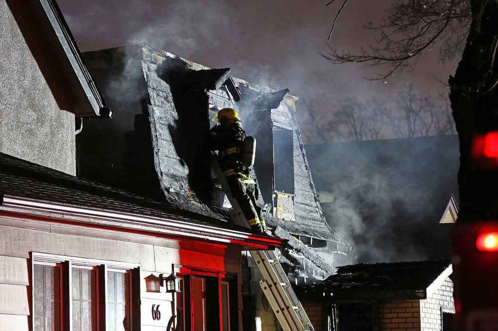 MIKE DEAL / WINNIPEG FREE PRESS
Firefighters were called to the two-storey house fire on Prince Edward Street early Friday morning. Two people managed to get out of the building, but two others are unaccounted for.