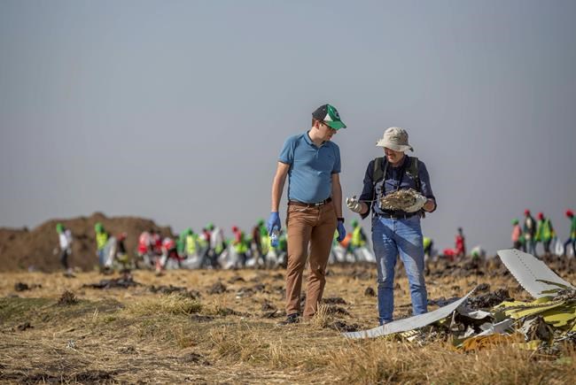 Foreign investigators examine wreckage at the scene where the Ethiopian Airlines Boeing 737 Max 8 crashed shortly after takeoff on Sunday killing all 157 on board, near Bishoftu, or Debre Zeit, south of Addis Ababa, in Ethiopia Tuesday, March 12, 2019. Ethiopian Airlines had issued no new updates on the crash as of late afternoon Tuesday as families around the world waited for answers, while a global team of investigators began picking through the rural crash site. (AP Photo/Mulugeta Ayene)
