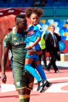 Brescia's Mario Balotelli holds his daughter Pia wearing a Napoli soccer team jersey, as he enters the pitch prior to the start of the Italian Serie A soccer match between Napoli and Brescia at the San Paolo stadium in Naples, Italy, Sunday, Sept. 29, 2019. (Cesare Abbate/ANSA Via AP)