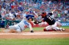 Los Angeles Dodgers' Joc Pederson, left, slides past Washington Nationals catcher Kurt Suzuki for a run on Cody Bellinger's single in the first inning of a baseball game, Friday, July 26, 2019, in Washington. (AP Photo/Patrick Semansky)