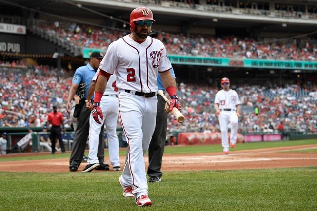 Washington Nationals' Adam Eaton (2) walks to the dugout after he was ejected by home plate umpire Jeremie Rehak, back left, during the first inning of a baseball game against the Los Angeles Dodgers, Sunday, July 28, 2019, in Washington. (AP Photo/Nick Wass)