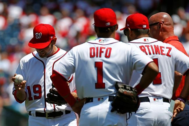 Washington Nationals starting pitcher Anibal Sanchez, left, reacts as he is relieved in the second inning of a baseball game against the New York Mets, Thursday, May 16, 2019, in Washington. Also pictured are shortstop Wilmer Difo (1), manager Dave Martinez (4) and head athletic trainer Paul Lessard. (AP Photo/Patrick Semansky)
