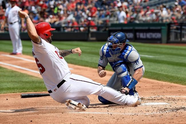 Washington Nationals' Matt Adams, left, is out at the plate against Los Angeles Dodgers catcher Will Smith during the second inning of a baseball game, Sunday, July 28, 2019, in Washington. (AP Photo/Nick Wass)