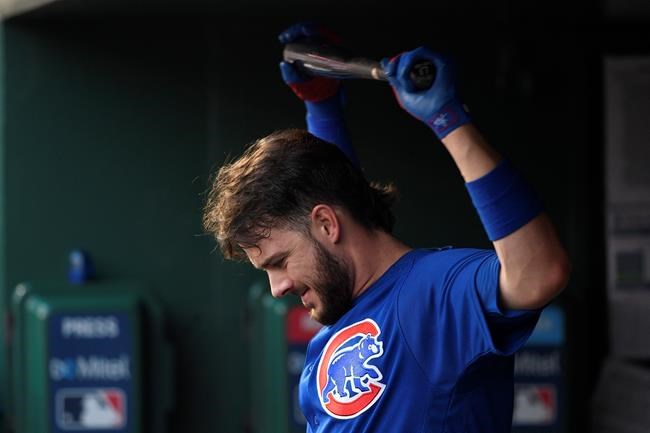 Chicago Cubs' Kris Bryant stretches with the bat in the dugout during the third inning of a baseball game against the Washington Nationals, Sunday, May 19, 2019, in Washington. (AP Photo/Nick Wass)