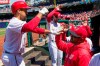 Washington Nationals' Anthony Rendon, left, celebrates his solo home run with manager Dave Martinez, right, during the first inning of a baseball game against the Philadelphia Phillies at Nationals Park, Wednesday, April 3, 2019, in Washington. (AP Photo/Alex Brandon)