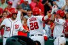 Washington Nationals catcher Kurt Suzuki celebrates his three-run homer with Matt Adams (15) and Asdrubal Cabrera during the fifth inning of a baseball game against the Cincinnati Reds at Nationals Park, Wednesday, Aug. 14, 2019, in Washington. (AP Photo/Alex Brandon)