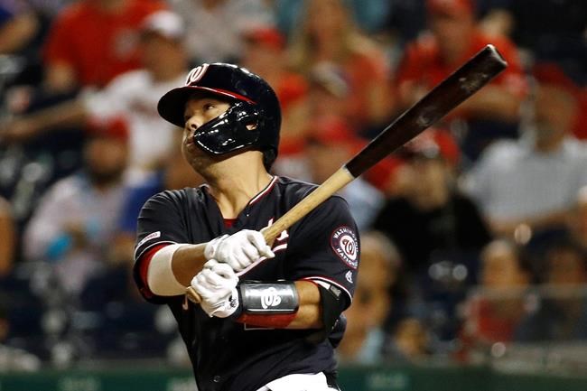 Washington Nationals' Kurt Suzuki watches his game-winning three-run home run in the team's baseball game against the New York Mets, Tuesday, Sept. 3, 2019, in Washington. Washington won 11-10. (AP Photo/Patrick Semansky)