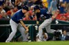 Milwaukee Brewers' Christian Yelich, right, celebrates his home run with third base coach Ed Sedar (0) during the 13th inning of a baseball game against the Washington Nationals, early Sunday, Aug. 18, 2019, in Washington. The Brewers won 15-14 in 14 innings. (AP Photo/Nick Wass)