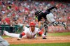 Washington Nationals' Juan Soto, left, slides home to score against Cleveland Indians catcher Eric Haase, back, during the fourth inning of a baseball game, Saturday, Sept. 28, 2019, in Washington. (AP Photo/Nick Wass)