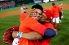 Washington Nationals' Juan Soto gets a kiss from his father, Juan Jose Soto, right, after defeating the Milwaukee Brewers 4-3 in a National League wild-card baseball game at Nationals Park, Tuesday, Oct. 1, 2019, in Washington. (AP Photo/Andrew Harnik)