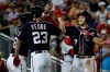 Washington Nationals' Trea Turner, right, celebrates after bringing home Victor Robles, left, and Erick Fedde (23) during the fourth inning of a baseball game against the Cincinnati Reds at Nationals Park, Monday, Aug. 12, 2019, in Washington. (AP Photo/Alex Brandon)