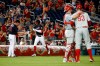 Washington Nationals' Victor Robles, second from left, rounds the bases on a solo home run past third base coach Bob Henley as Philadelphia Phillies relief pitcher Pat Neshek (93) speaks with catcher J.T. Realmuto in the eighth inning of the second baseball game of a doubleheader, Wednesday, June 19, 2019, in Washington. Washington won 2-0. (AP Photo/Patrick Semansky)