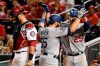 Los Angeles Dodgers' Russell Martin (55) celebrates with David Freese (25) after hitting a two-run home run off Washington Nationals relief pitcher Hunter Strickland during the ninth inning in Game 3 of a baseball National League Division Series on Sunday, Oct. 6, 2019, in Washington. At left is Nationals catcher Kurt Suzuki. (AP Photo/Susan Walsh)