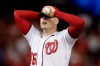 Washington Nationals starting pitcher Patrick Corbin covers his face after allowing a two-run double to Los Angeles Dodgers Russell Martin during the sixth inning in Game 3 of a baseball National League Division Series on Sunday, Oct. 6, 2019, in Washington. The Dodgers won 10-4. (AP Photo/Julio Cortez)