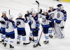 Winnipeg Jets goalie Laurent Brossoit (30) is congratulated by Sami Niku, of Finland, and other teammates following an NHL hockey game against the Carolina Hurricanes in Raleigh, N.C., Friday, March 8, 2019. (AP Photo/Gerry Broome)