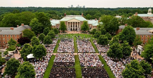 This May 21, 2018 photo shows the Wake Forest University commencement on Hearn Plaza, in Winston-Salem, N.C. Dozens of people were charged Tuesday, March 12, 2019, in a scheme in which wealthy parents allegedly bribed college coaches and other insiders to get their children into some of the nation's most elite schools. The coaches worked at such schools as Wake Forest, Yale, Stanford, Georgetown, the University of Texas, the University of Southern California and the University of California, Los Angeles. (Walt Unks/The Winston-Salem Journal via AP)