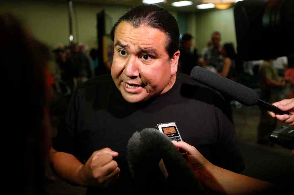 CP
Protester Clayton Thomas-Muller speaks with media in Winnipeg on Thursday, August 20, 2015. A speech by NDP Leader Tom Mulcair to close to 1,000 NDP supporters in Winnipeg was interrupted by protesters Thursday night. (John Woods / The Canadian Press)