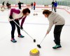 In this March 4, 2018 photo, Robin Quinn, left, and Mimi Quinn practice sweeping during an all-ages learn-to-curl session at the Aksarben Curling Club in Omaha, Neb. Curling clubs across the United States have seen a major uptick in interest in the sport in the wake of the U.S. men winning the gold medal at the Winter Olympics. The Aksarben Curling Club in Omaha reports that 1,000 people will participate in its learn-to-curl events this winter and spring. That is more than twice as many as in a normal year. (AP Photo/Nati Harnik)