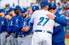 Kansas City Royals coach Ned Yost embraces Omaha Storm Chasers coach Brian Poldberg (27) prior to an exhibition baseball game at Werner Park in Papillion, Neb., Monday, March 25, 2019. (Brendan Sullivan/Omaha World-Herald via AP)