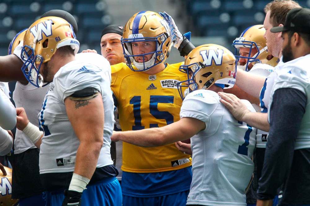 MIKE DEAL / WINNIPEG FREE PRESS
Winnipeg Blue Bombers QB Matt Nichols (15) is patted on the head prior to start of the team's practice at Investors Group Field Sunday. The team has announced Nichols will be starting quarterback at the Bombers' Thursday game.