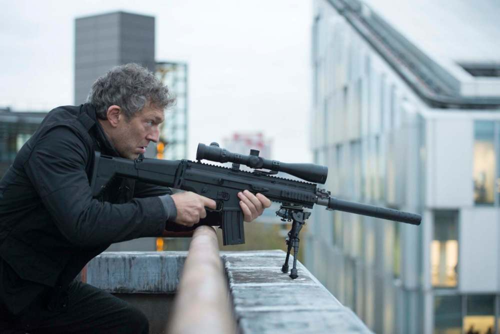 Jasin Boland / Universal Pictures
Actor Vincent Cassel takes aim in the film Jason Bourne. Filmmakers are using familar backdrops to add to cinematic tension.