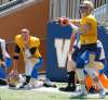 BORIS MINKEVICH / WINNIPEG FREE PRESS
Relegated quarterback Drew Willy (left) looks on as new starter Matt Nichols prepares to throw a pass during Tuesday’s practice at Investors Group Field.