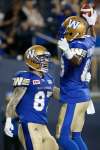 John Woods / The Canadian Press
Winnipeg Blue Bombers' Clarence Denmark (89) and Rory Kohlert (87) celebrate Denmark's touchdown against the Hamilton Tiger-Cats during the first half.