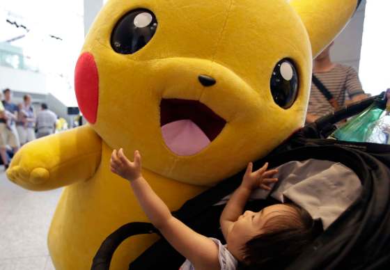 Shizuo Kambayashi / The Associated Press FilesA girl on a baby stroller plays with Pokemon character Pikachu during a special gathering event of Pikachu at Minatomirai shopping district in Yokohama, near Tokyo, Wednesday.