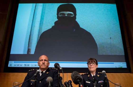 JUSTIN TANG / THE CANADIAN PRESSVideo footage showing Aaron Driver is seen behind RCMP Deputy Commissioner Mike Cabana (left) and Assistant Commissioner Jennifer Strachan during a press conference for what the RCMP are calling a terrorism incident, in Strathroy, Ontario yesterday, on Thursday, Aug. 11, 2016 in Ottawa.