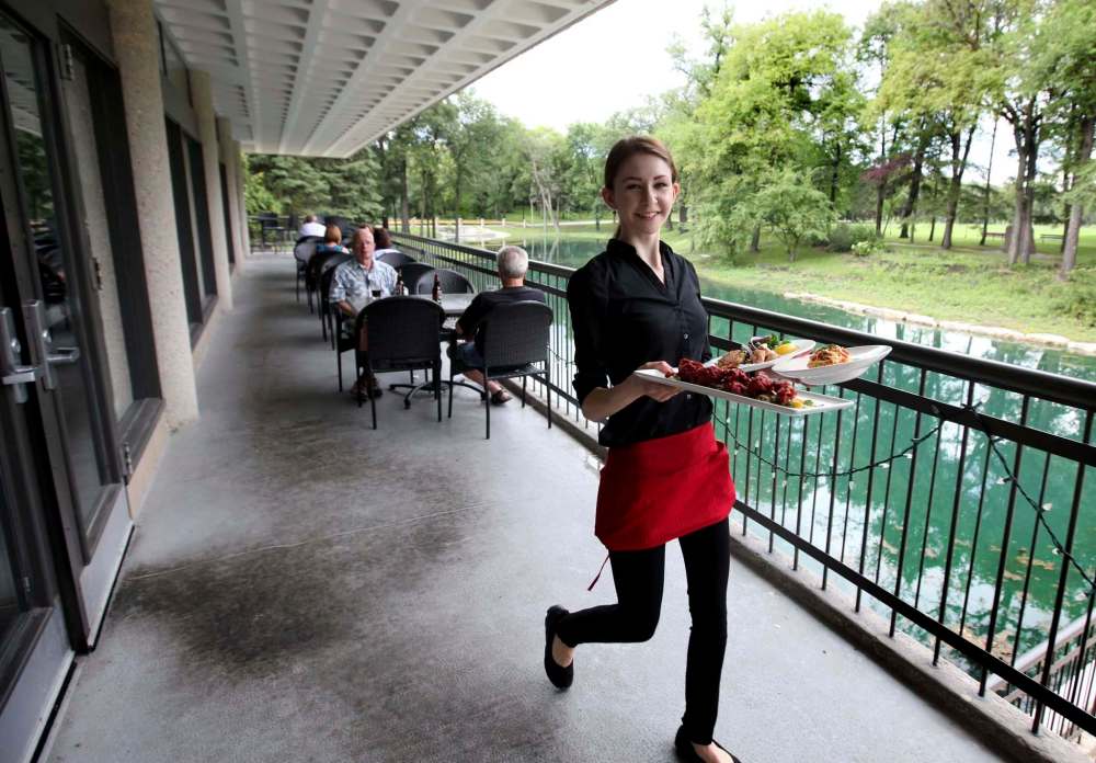 RUTH BONNEVILLE / WINNIPEG FREE PRESS
Ashley Pidwerbesky serves up Arctic char salad, beet fritters and smoked Manitoba goldeye pasta on Prairie Edge’s picturesque patio, which overlooks the Kildonan Park duck pond.