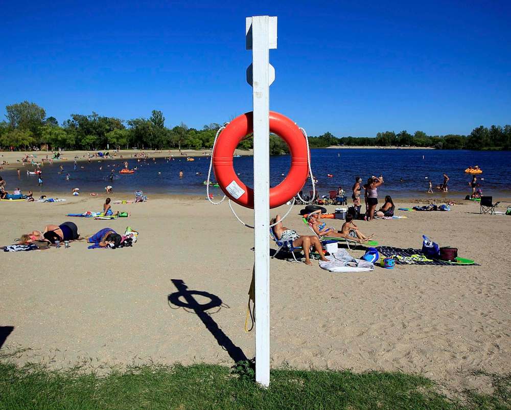 PHIL HOSSACK / WINNIPEG FREE PRESS
A lone life ring stands guard in lieu of lifeguards while Beachgoers enjoy the water at St Malo Provincial Park Monday afternoon.