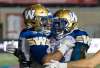 Bombers running back Andrew Harris (left) celebrates his fourth-quarter touchdown against the Alouettes with teammate Quincy McDuffie.