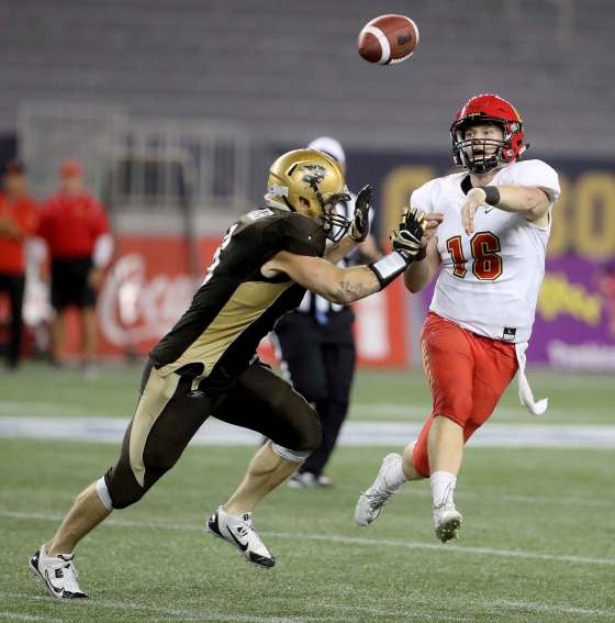 TREVOR HAGAN / WINNIPEG FREE PRESSCalgary Dinos quarterback Jimmy Underdahl throws a pass during second half CIS football action against the Manitoba Bisons Thursday.