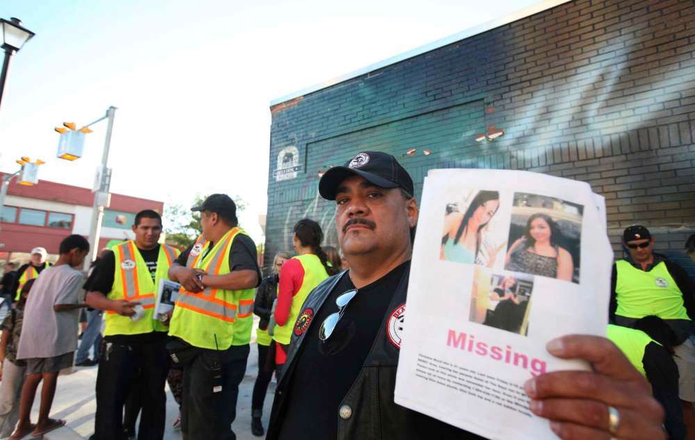 RUTH BONNEVILLE / WINNIPEG FREE PRESS
James Favel leads the Friday night search for Christine Wood (far left)with teams of volunteers near the Bell Tower on Selkirk Avenue.