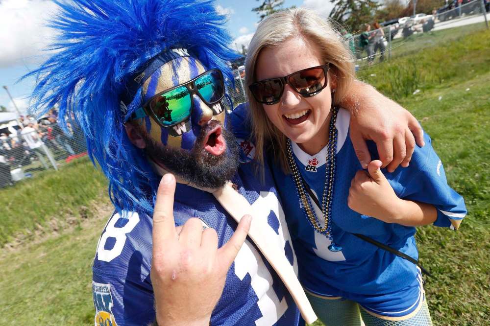 JOHN WOODS / THE CANADIAN PRESS
Winnipeg Blue Bombers fans Ryan Krause, left, and Meaghan Bale party it up during their tail-gating party prior to the Banjo Bowl against the Saskatchewan Roughriders at Investors Group Field.