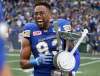 RUTH BONNEVILLE / WINNIPEG FREE PRESS
Winnipeg Blue Bomber #93 Justin Cole holds the Banjo Bowl trophy as he celebrates after his team won against The Saskatchewan Roughriders at Investors Group Field Saturday afternoon. The final score was 17 -10.