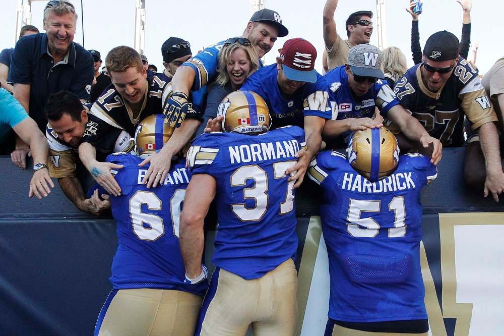 JOHN WOODS / THE CANADIAN PRESS
Winnipeg Blue Bombers' Stanley Bryant (66), Chris Normand touchdown against the Toronto Argonauts during second half CFL action in Winnipeg.