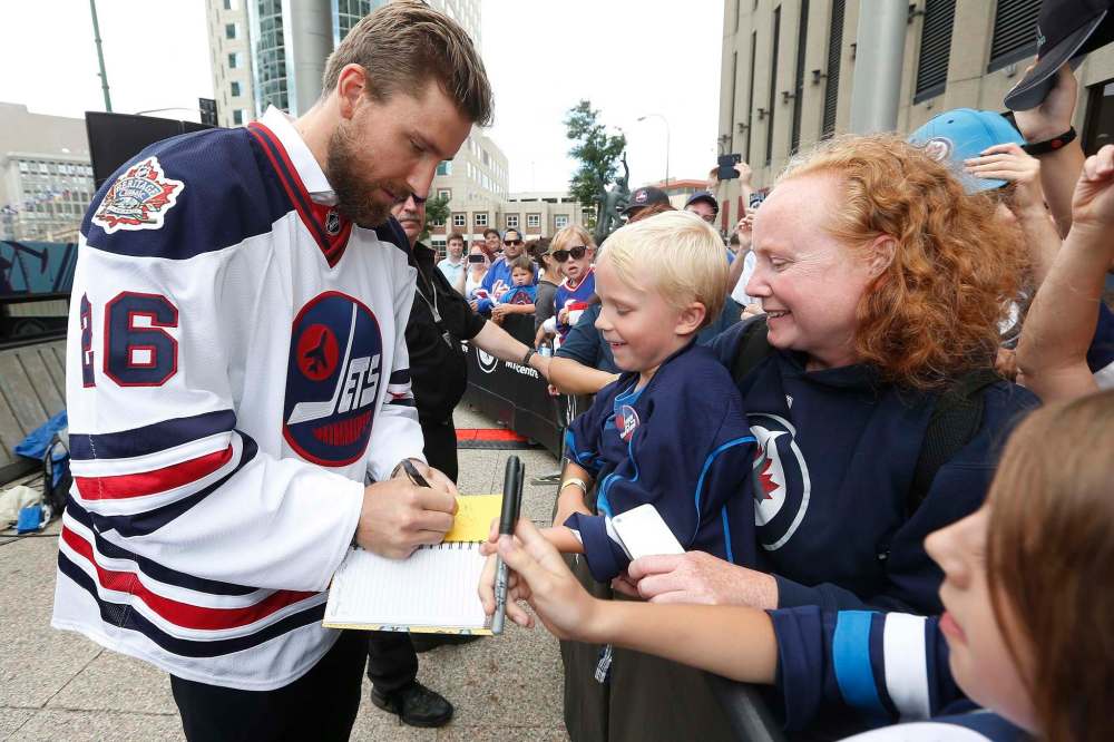 JOHN WOODS / THE CANADIAN PRESS files
Winnipeg Jets forward Blake Wheeler signs autographs for fans after the National Hockey League announced the rosters at a Tim Hortons NHL Heritage Classic press event Aug. 5 at Winnipeg’s Portage and Main intersection.
