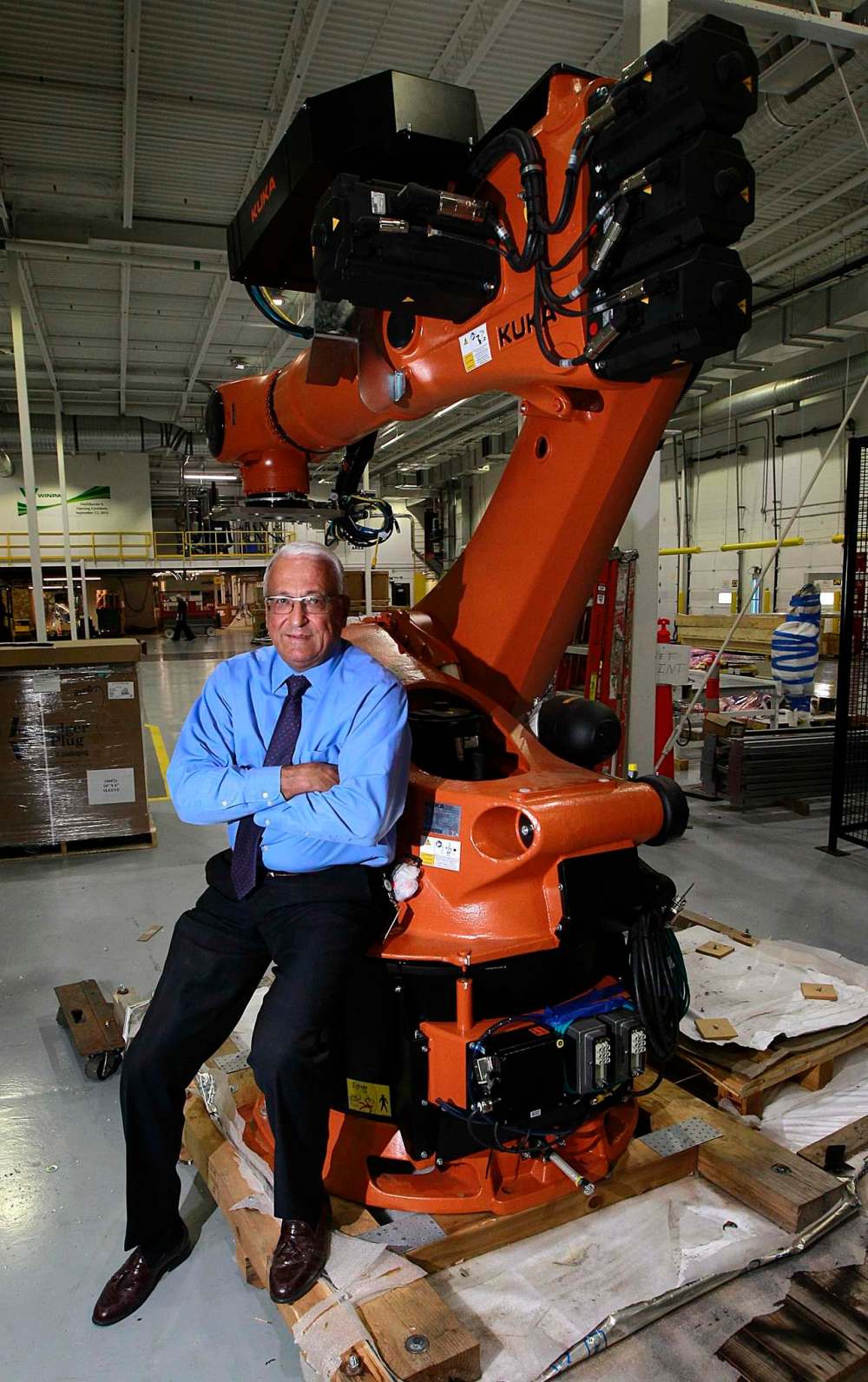 PHIL HOSSACK / WINNIPEG FREE PRESS
Winpak Division president Dave Johns sits on a robot that is part of the company’s new $25-million state-of-the art plastic extrusion line.